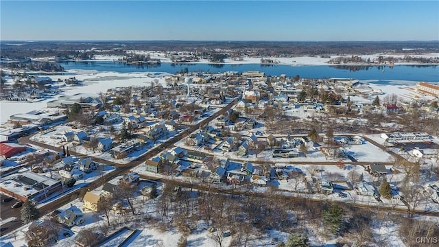 snowy aerial view with a water view