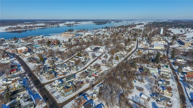 snowy aerial view featuring a water view