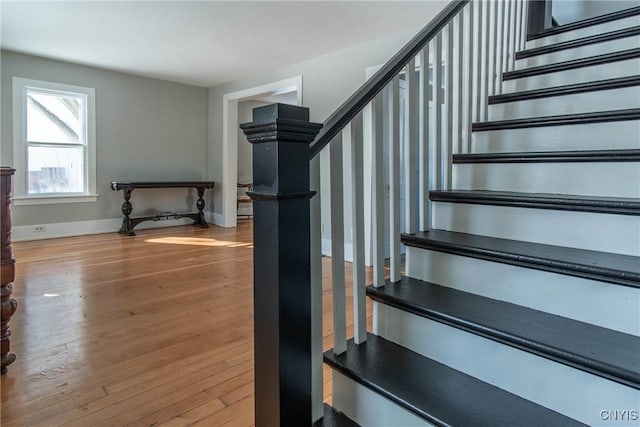 stairway with hardwood / wood-style floors