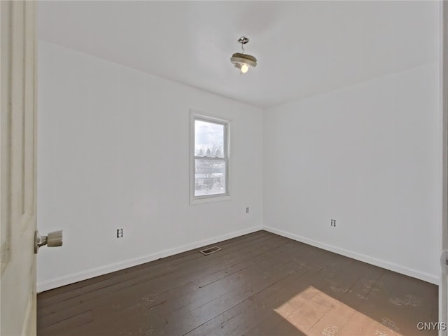 spare room with dark hardwood / wood-style flooring