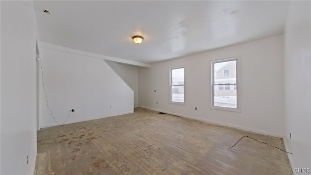 empty room with light hardwood / wood-style flooring