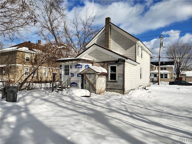 view of snow covered back of property