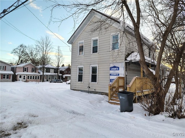 view of snow covered rear of property