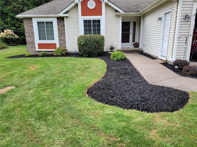 property entrance with a yard