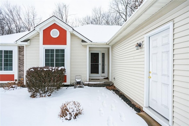 view of snow covered property entrance