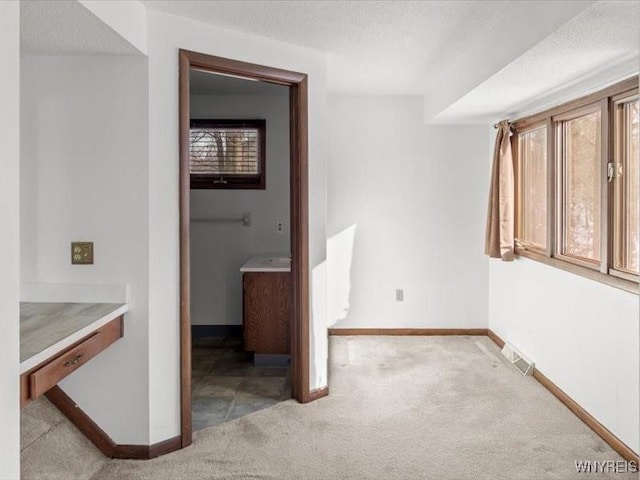 hallway with light colored carpet