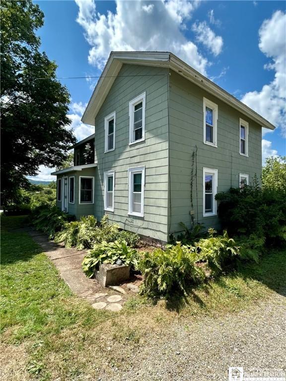 rear view of house featuring a lawn