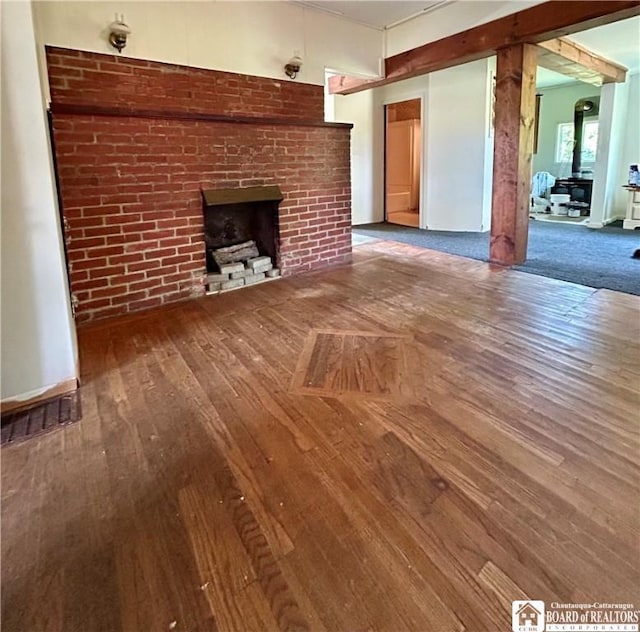 unfurnished living room featuring a brick fireplace