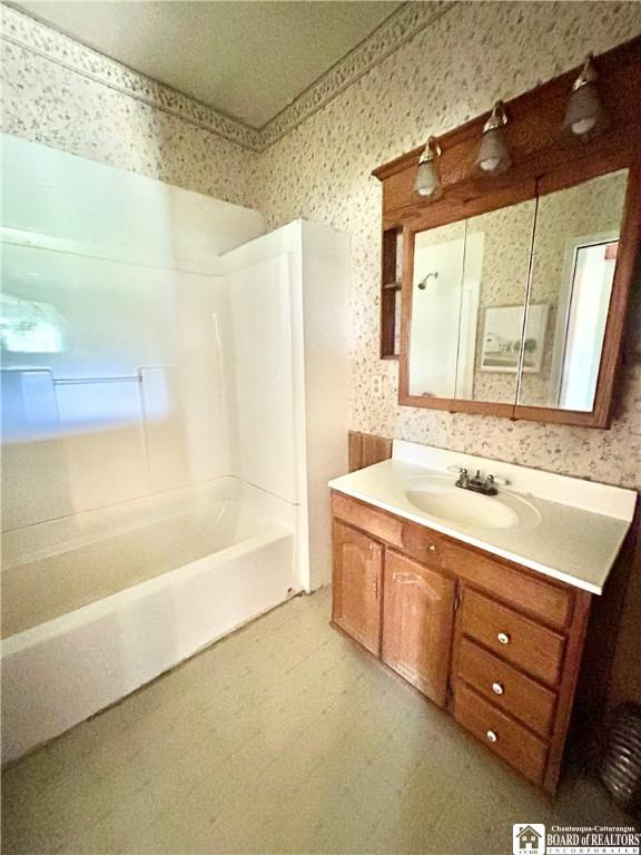 bathroom featuring vanity and bathing tub / shower combination