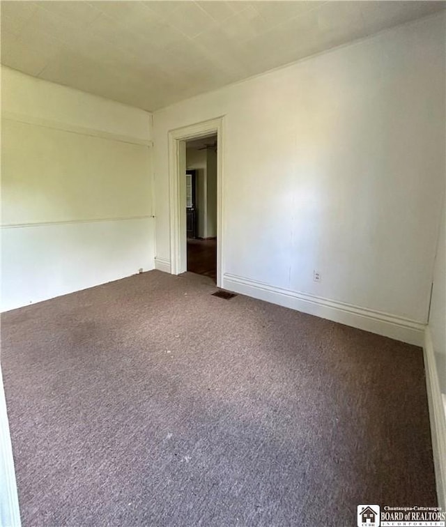 spare room featuring carpet floors