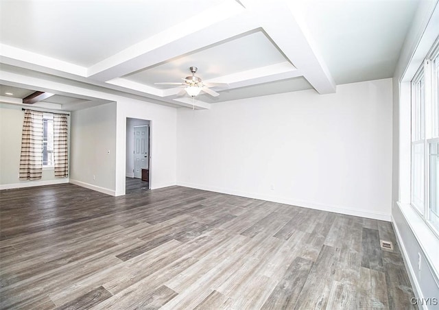 spare room with hardwood / wood-style floors, beam ceiling, and ceiling fan