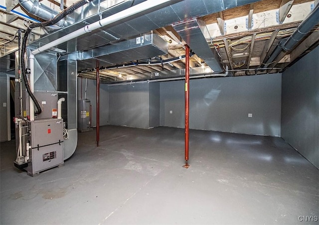 basement featuring heating unit and water heater