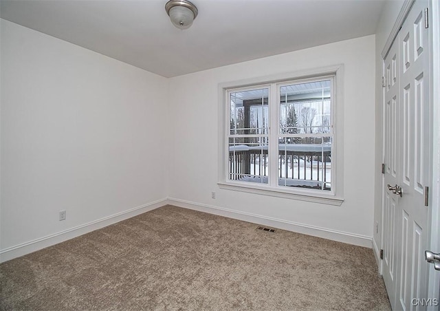 unfurnished room featuring carpet flooring