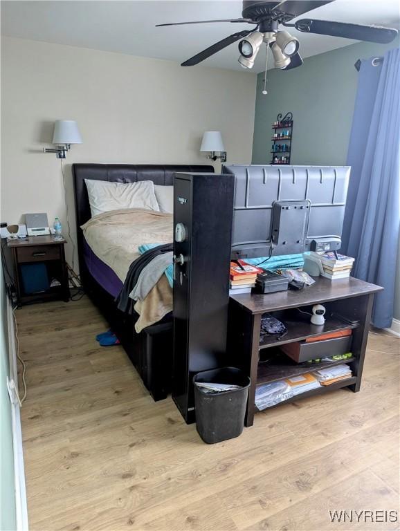 bedroom with a ceiling fan and wood finished floors