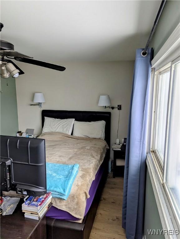 bedroom with a ceiling fan and wood finished floors