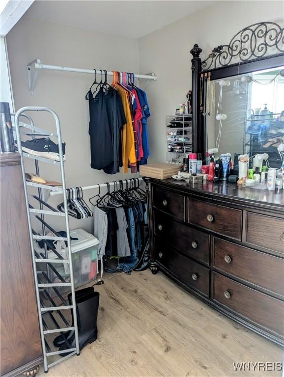 walk in closet featuring light wood-style flooring