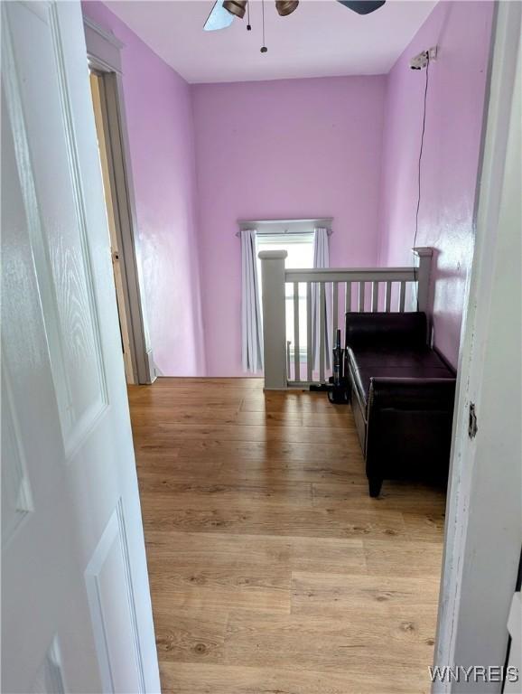 bedroom with ceiling fan and light wood-style floors