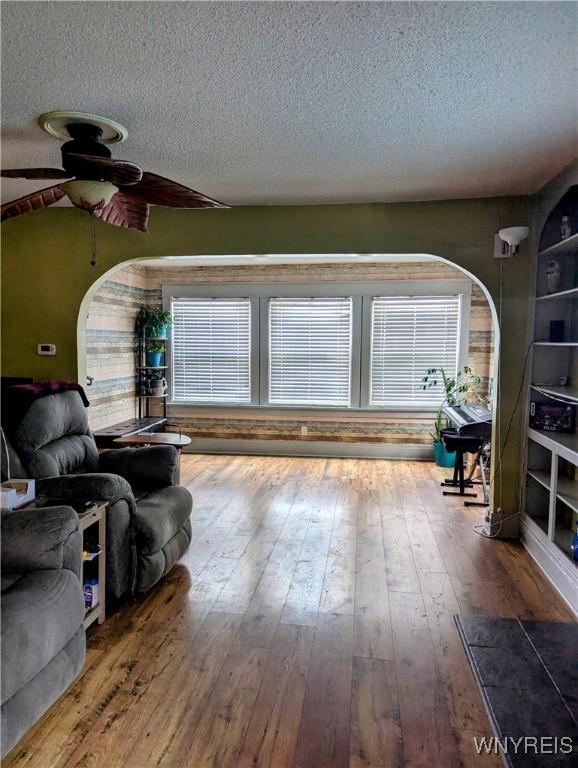 living room featuring hardwood / wood-style flooring and a textured ceiling