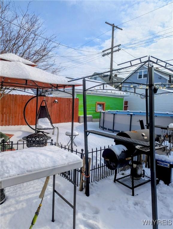 snow covered patio with fence