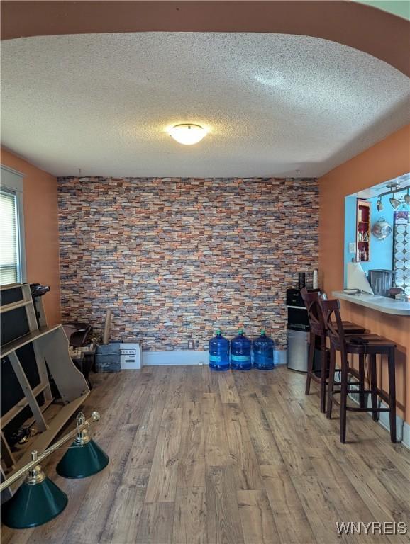 interior space featuring a textured ceiling and wood finished floors