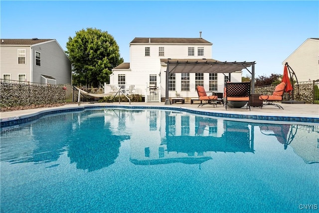 view of pool featuring a pergola, a fire pit, and a patio area