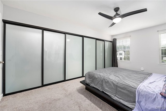 carpeted bedroom with ceiling fan