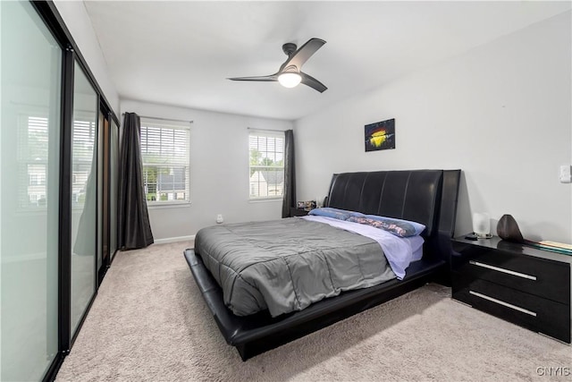 bedroom featuring light carpet and ceiling fan