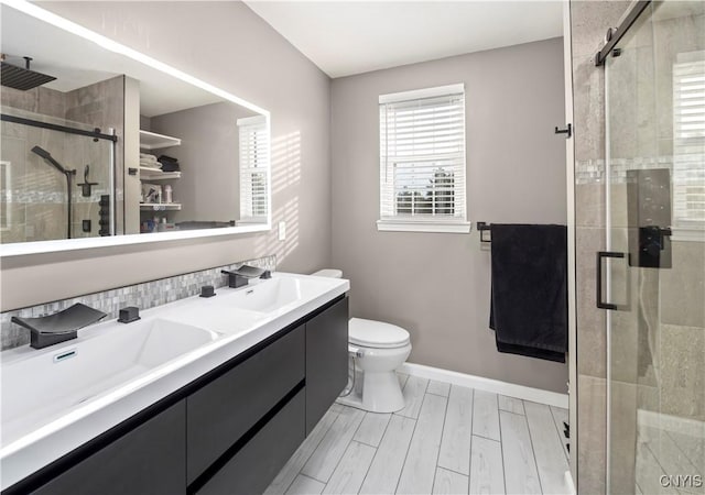 bathroom with walk in shower, vanity, and toilet