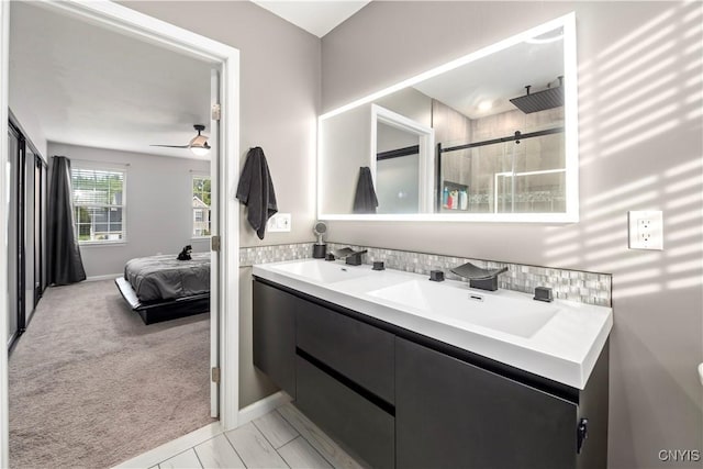 bathroom featuring vanity, an enclosed shower, and ceiling fan