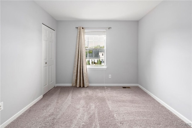 unfurnished room featuring carpet flooring