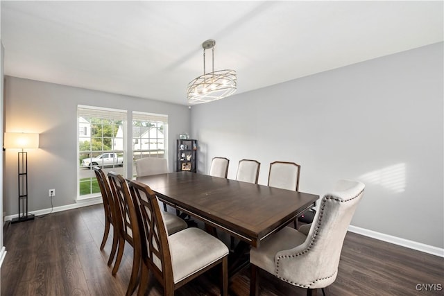 dining space featuring dark hardwood / wood-style floors and a notable chandelier