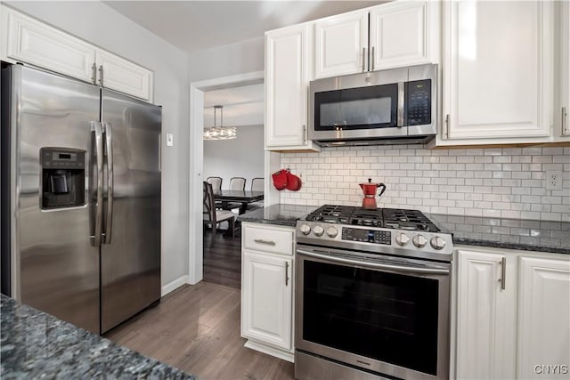 kitchen featuring white cabinetry, dark stone counters, and appliances with stainless steel finishes