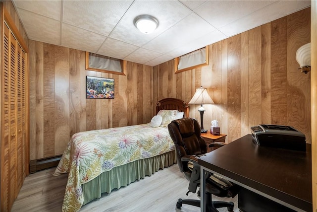 11995 E Lake Rd, Wayne, NY 14840 - bedroom featuring wooden walls, an office area, baseboard heating, and wood finished floors