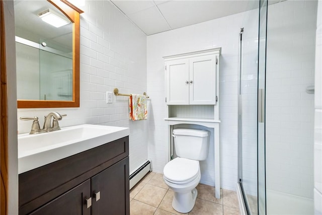 bathroom with a baseboard radiator, tile patterned flooring, vanity, walk in shower, and toilet