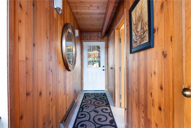 entryway with tile patterned floors, wooden walls, a baseboard heating unit, and wooden ceiling