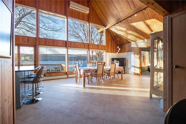 dining room with rail lighting, wooden walls, high vaulted ceiling, a wall mounted air conditioner, and wooden ceiling