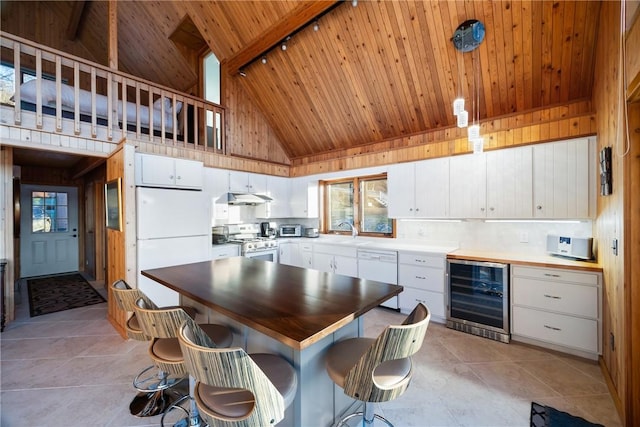 kitchen featuring white cabinetry, high vaulted ceiling, wine cooler, and white appliances