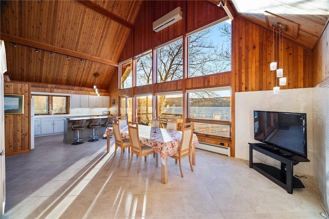 tiled dining area with beamed ceiling, a baseboard radiator, a wall unit AC, and high vaulted ceiling