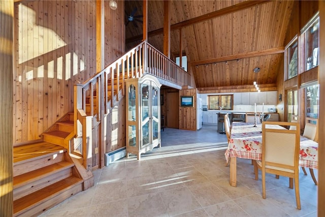 tiled dining space with wood ceiling, wooden walls, high vaulted ceiling, and beamed ceiling