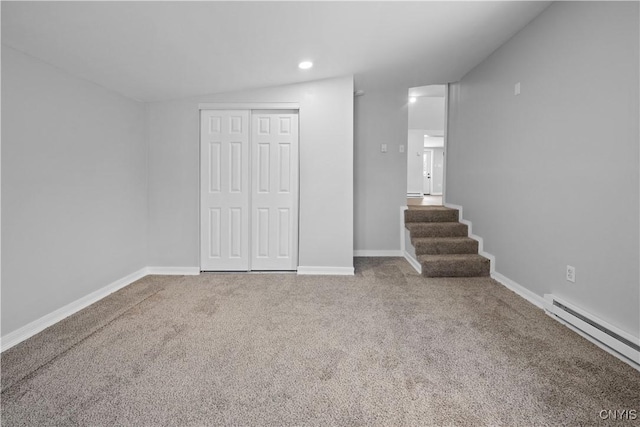 basement featuring a baseboard radiator and carpet flooring