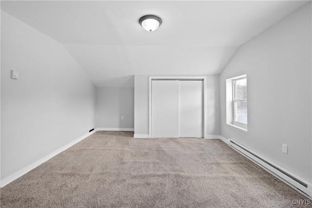 bonus room with a baseboard radiator, lofted ceiling, and light carpet