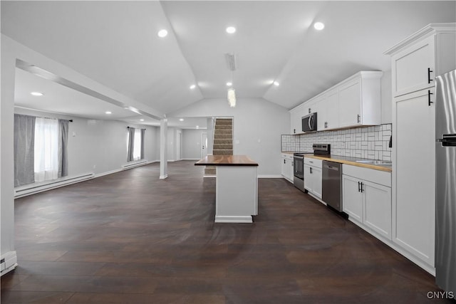 kitchen with a baseboard heating unit, white cabinetry, appliances with stainless steel finishes, and butcher block counters