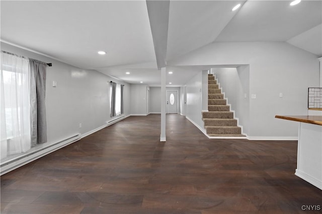 basement with dark hardwood / wood-style floors and baseboard heating