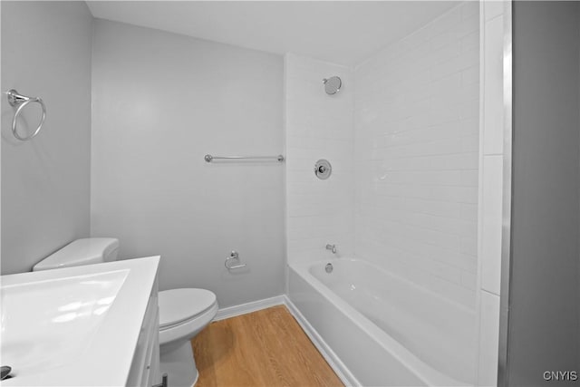 full bathroom featuring shower / washtub combination, hardwood / wood-style floors, vanity, and toilet