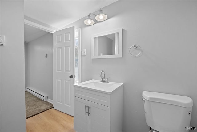 bathroom featuring vanity, wood-type flooring, a baseboard radiator, and toilet