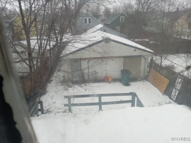 view of snowy exterior with a garage