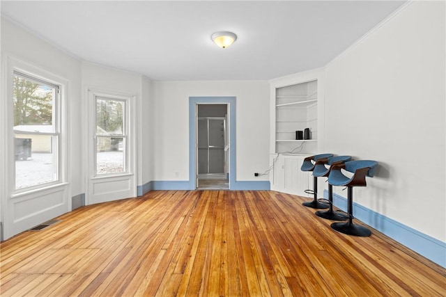 interior space featuring built in features and light hardwood / wood-style flooring