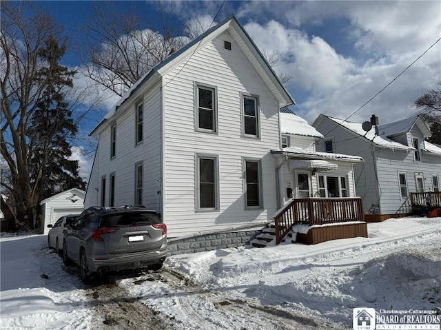 view of front of property with a garage and an outdoor structure