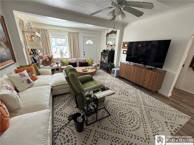 living room featuring crown molding, dark wood-type flooring, and ceiling fan