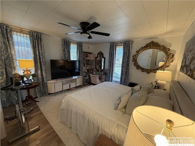 bedroom with hardwood / wood-style flooring and ceiling fan